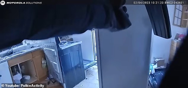 Bodycam footage shows the house in a state of disarray, with broken glass and plastic on the floor