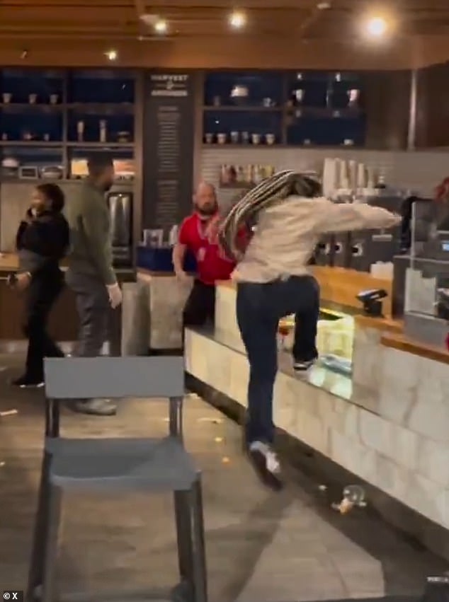 After leaving the store for a moment, she steps back and jumps over the cash register