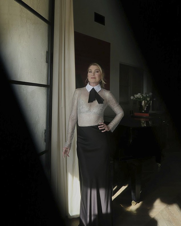 She posed by a window to show off her sparkling top and flowy skirt