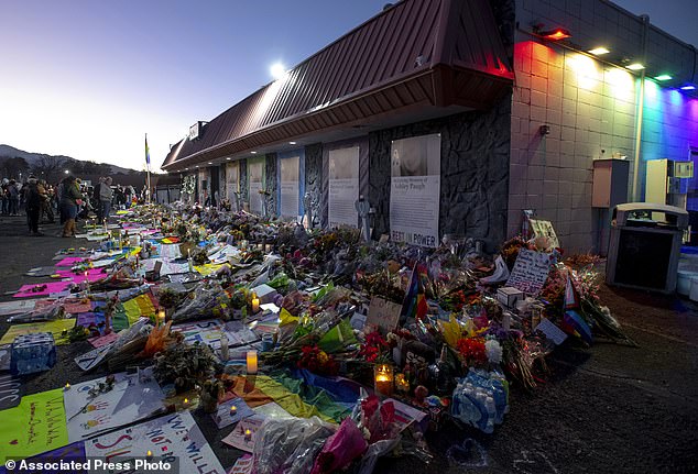 Candles, flowers and cards stand outside Club Q in memory of the five victims who died