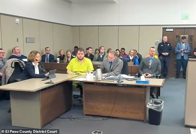 Aldrich, then 22, sat upright in a chair during the hearing and appeared alert as he was read in connection with the Colorado shootings, which included murder and hate crimes