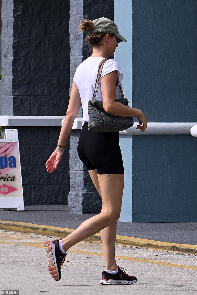 The blonde beauty opted for comfortable black sneakers and carried a navy blue quilted bag over her shoulder, while she accessorized with small silver hoop earrings