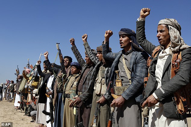 Houthi fighters and tribesmen hold a rally against US and British attacks on Houthi-run military sites near Sanaa, Yemen