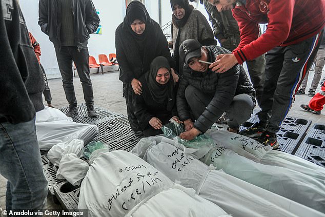 Relatives of Palestinians killed in Israeli attacks cry over their bodies at An-Najjar Hospital in Rafah, Gaza, on Wednesday