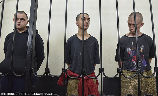 British citizens Aiden Aslin (L) and Shaun Pinner (R) and Moroccan Saaudun Brahim (C) attend a sentencing hearing at the Supreme Court of the self-proclaimed Donetsk People's Republic (DPR) in Donetsk, eastern Ukraine on June 9, 2022 .