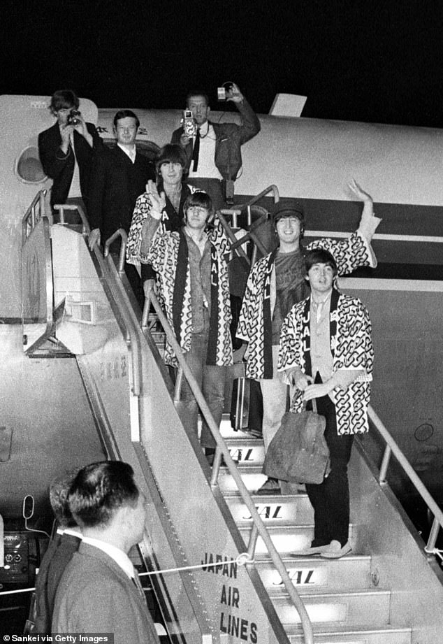 The members of Beatles pose for photos upon arrival at Tokyo International Airport on June 29, 1966 in Tokyo, Japan