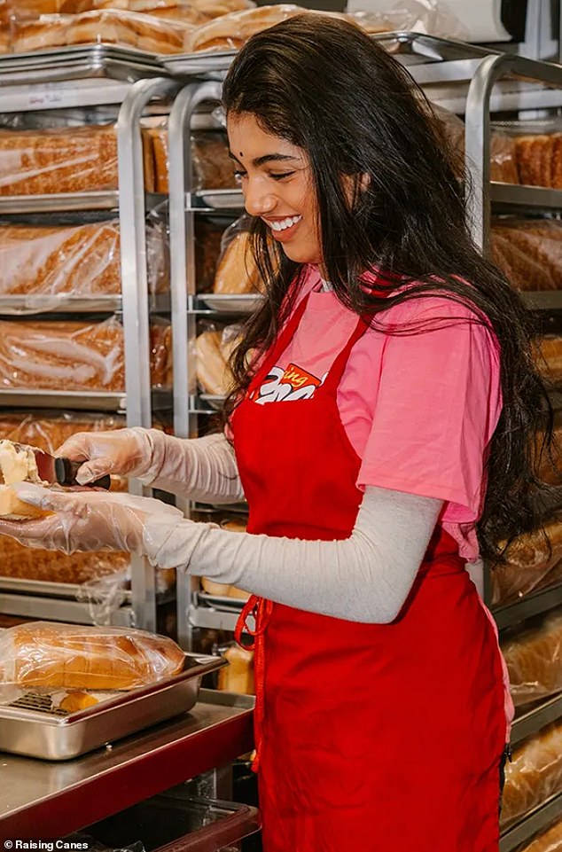 Avantika spread a slice of bread in the kitchen