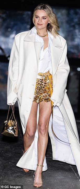 The Tennessee native completed her look with open-toed heels and also carried a metallic gold bag