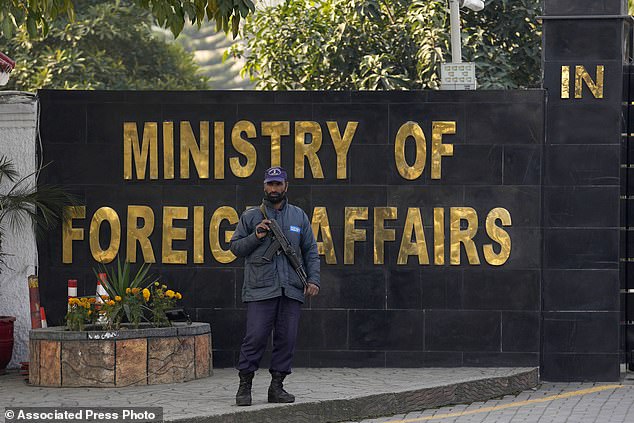 A police officer stands guard at the main entrance of the Pakistani Ministry of Foreign Affairs in Islamabad, Pakistan on Thursday