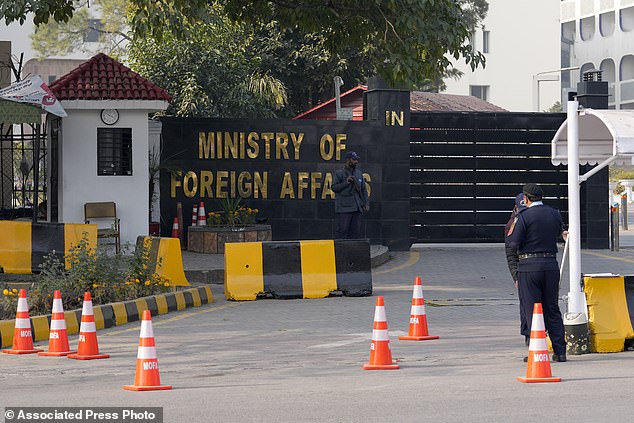 Police officers stand guard at the main entrance of the Pakistani Ministry of Foreign Affairs in Islamabad, Pakistan on Thursday