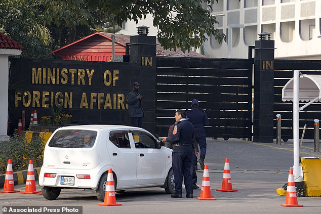 Police officers search a car at the main entrance of the Pakistani Foreign Ministry in Islamabad, Pakistan on Thursday