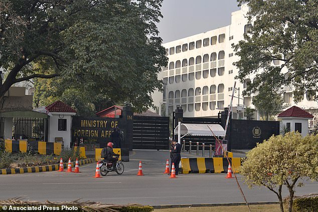 Police officers stand guard at the main entrance of the Pakistani Ministry of Foreign Affairs in Islamabad, Pakistan on Thursday