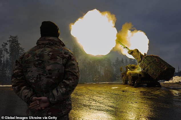 A Ukrainian soldier stands near the Archer Artillery System before firing at Russian positions