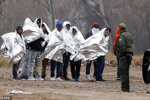 Migrants line up as they prepare to be picked up by Border Patrol agents in Eagle Pass, Texas, U.S., January 14, 2024