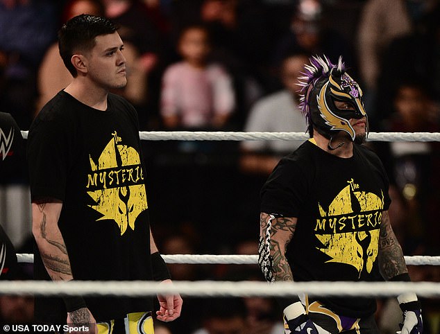 Mysterio debuted alongside his father, Rey Mysterio (right), before turning on him