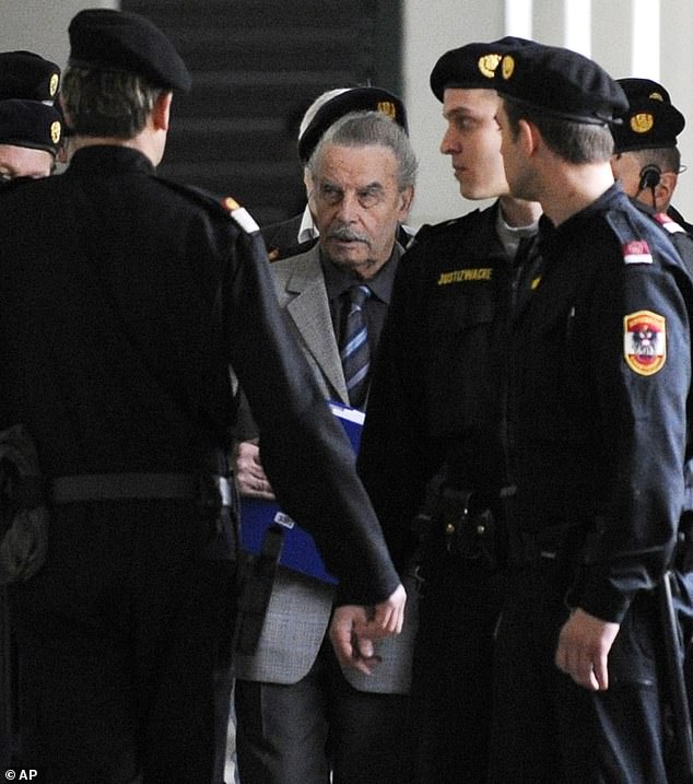 Josef Fritzl, center, is escorted to a break during the second day of his trial at the provincial courthouse in St. Poelten, Austria, on Tuesday, March 17, 2009