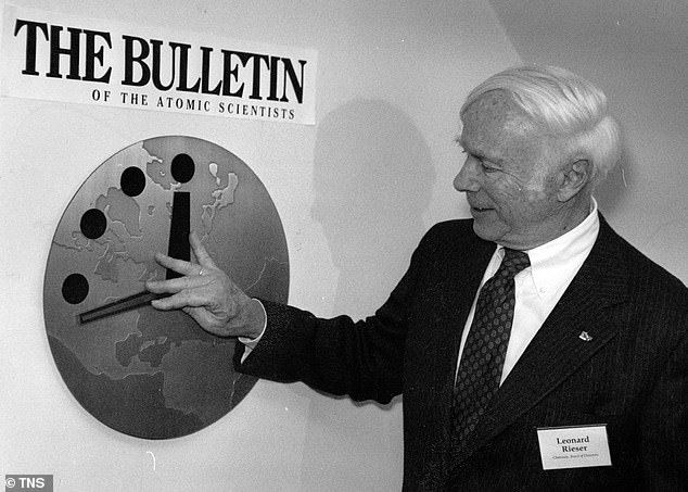 Dr.  Leonard Rieser, chairman of the board of directors of the Bulletin of the Atomic Scientists, moves the Doomsday Clock hand back to 17 minutes to midnight in offices near the University of Chicago on November 26, 1991