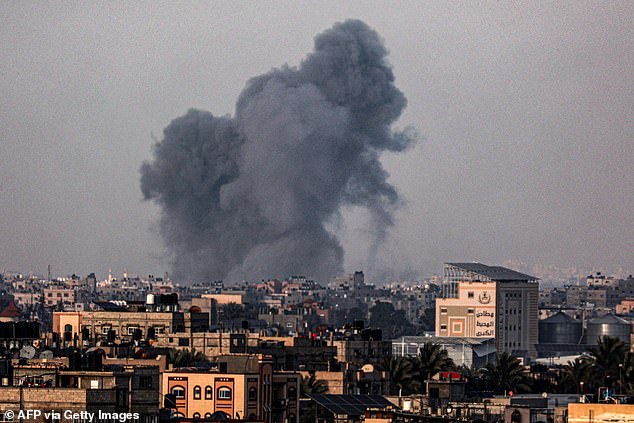 MailOnline predicts the clock could move closer to midnight as the war between Israel and Hamas continues.  Photo shows clouds of smoke over Khan Yunis in the southern Gaza Strip during the Israeli bombardment on January 18