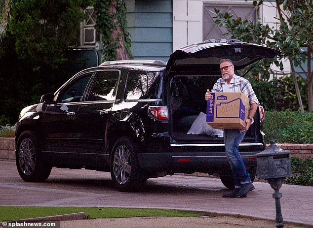 The 56-year-old actor was pictured carrying some heavy boxes from an SUV to Calo's house