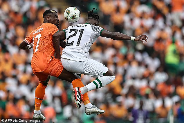 Ivory Coast defender Serge Aurier (L) fights for the ball with Nigerian Calvin Bassey