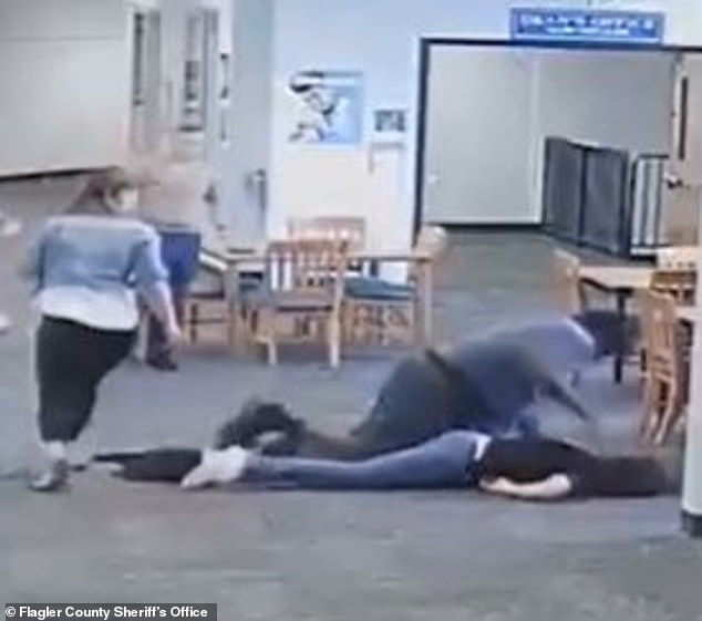 Surveillance video shows the 6'6"270-pound teen knocking Naydich to the ground in his special needs classroom before kneeling and punching her in the head and back