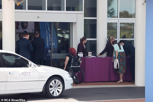 People gather on Friday for the funeral of father and daughter