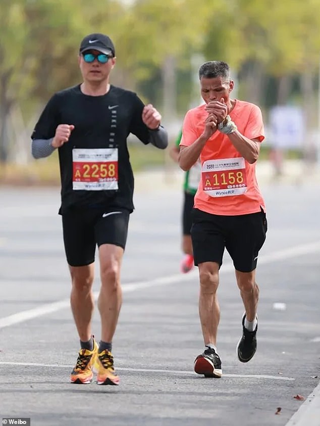 Footage shows Uncle Chen puffing on a cigarette as other runners run alongside him