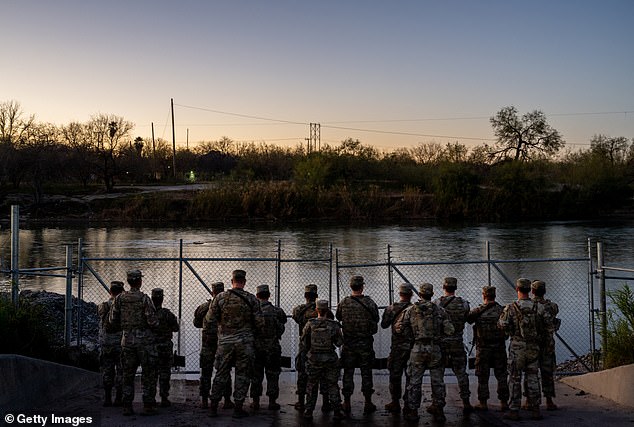 National Guard soldiers stand guard on the banks of the Rio Grande River at Shelby Park on January 12, 2024 in Eagle Pass, Texas