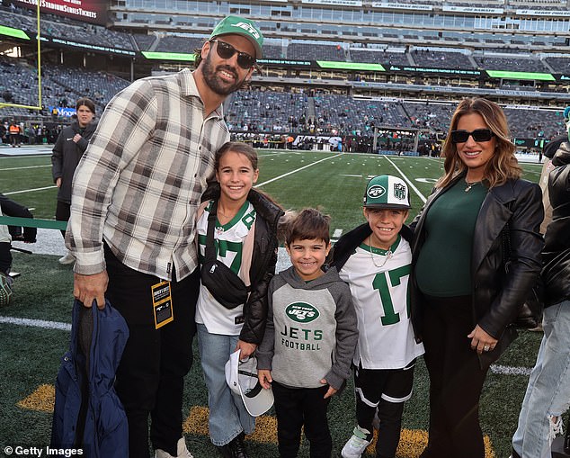 Eric Decker, who played eight seasons in the NFL before retiring in 2018;  the couple and their three children are pictured at a Jets game in New Jersey in November 2023