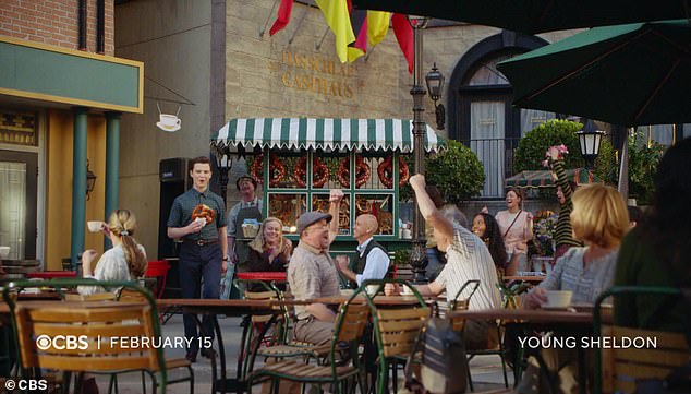 The preview opens with Sheldon enjoying a large Bavarian pretzel, apparently being cheered on by a few Germans.