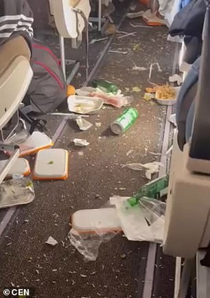 Shocking footage taken in the wake of devastating turbulence shows meals, trays, cutlery and bottles and cups strewn across the aisles