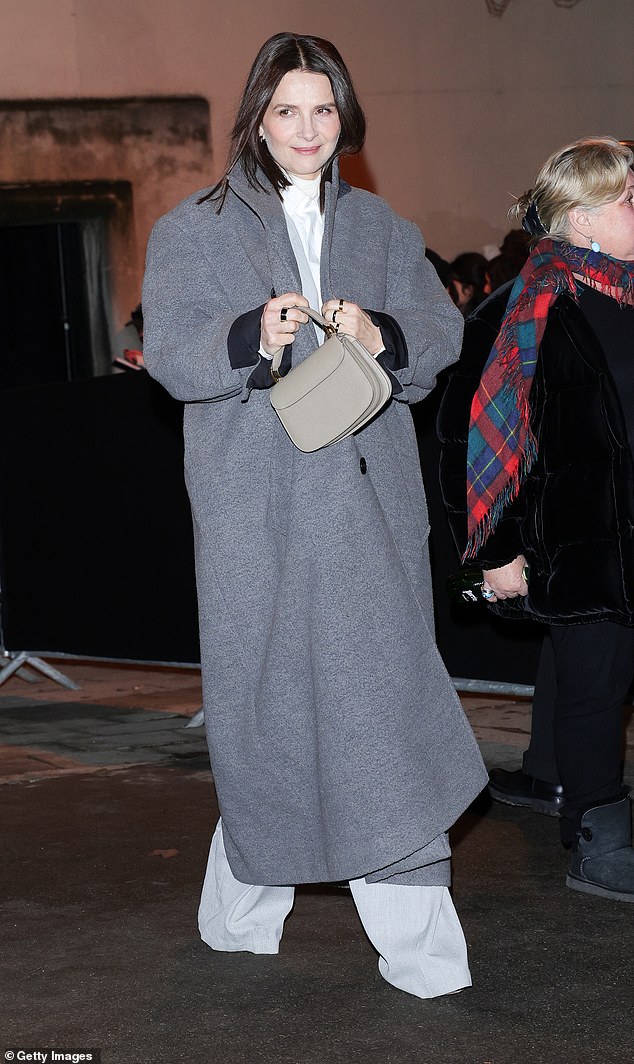 The French actress carried her belongings in a taupe top-handle bag adorned with a series of chunky rings.