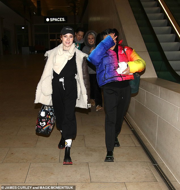 Angela Scanlon, 40, (pictured right) opted for a black tracksuit and stayed warm in a fluffy cream coat and scarf - while pro dancer Nancy Xu, 32, put on a low-key show