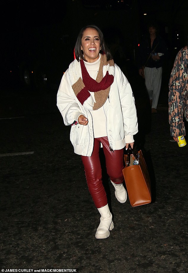 Miami-born Janette showed off her fashion sense in red leggings and cream Chelsea boots, paired with a cream turtleneck and a matching jacket