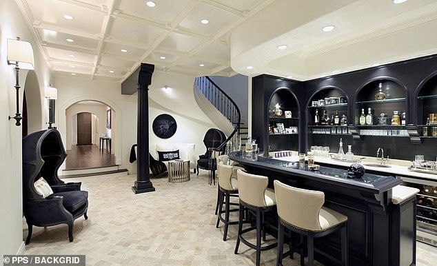 The house has a lovely large bar with a tasteful black and white design that would be ideal for a party or just a drink.