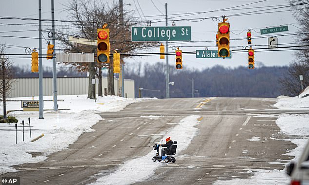 A person crosses South Pine Street in downtown Florence, Alabama, on Thursday as Storm Indigo continues to rock the US