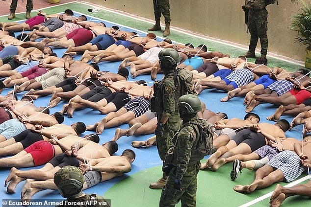 After Thursday's raid, the military shared photos of handcuffed prisoners in their underwear lying face down in prison yards as soldiers stood guard (photo)