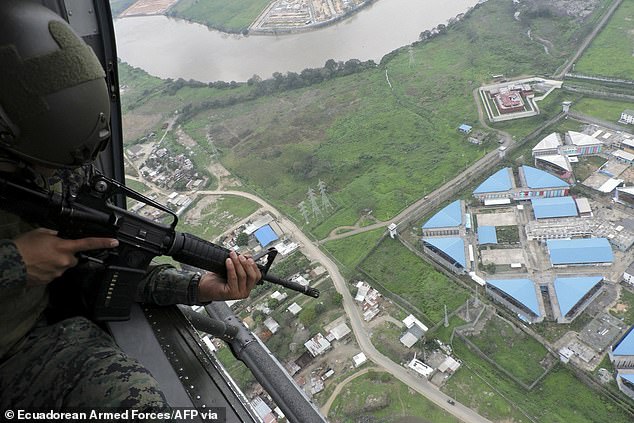 A member of the military monitors the Regional 8 prison complex from a helicopter during an operation in Guayaquil, Ecuador, on January 18