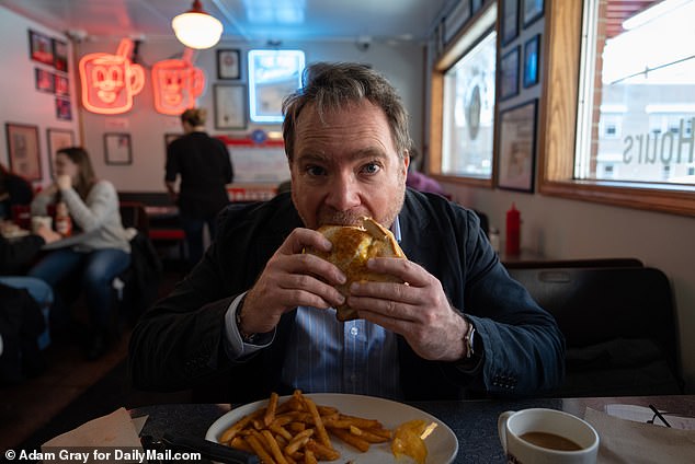 The Trump Tower Burger is an architectural collection of patties, grilled cheese, macaroni and cheese and more cheese sauce.  It's a job best done with two hands, a big mouth and antacids