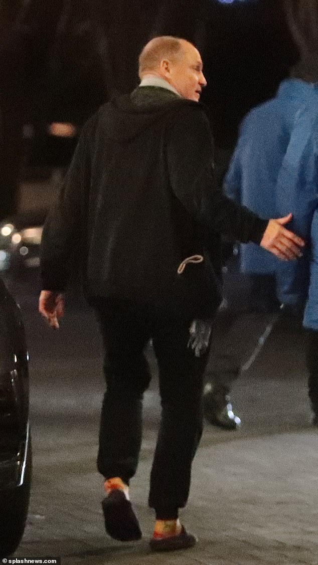 Woody wore black embellished sweatpants and a zip-up hoodie for the occasion