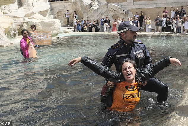 Environmentalists were removed from the famous Trevi Fountain by police officers in May