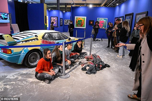 Last Generation activists threw flour on a car painted by the pop art icon on display at Milan's Fabbrica del Vapore art center in November 2022