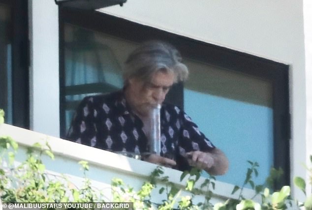 Morris is seen smoking a hookah before meeting Hunter at his California home