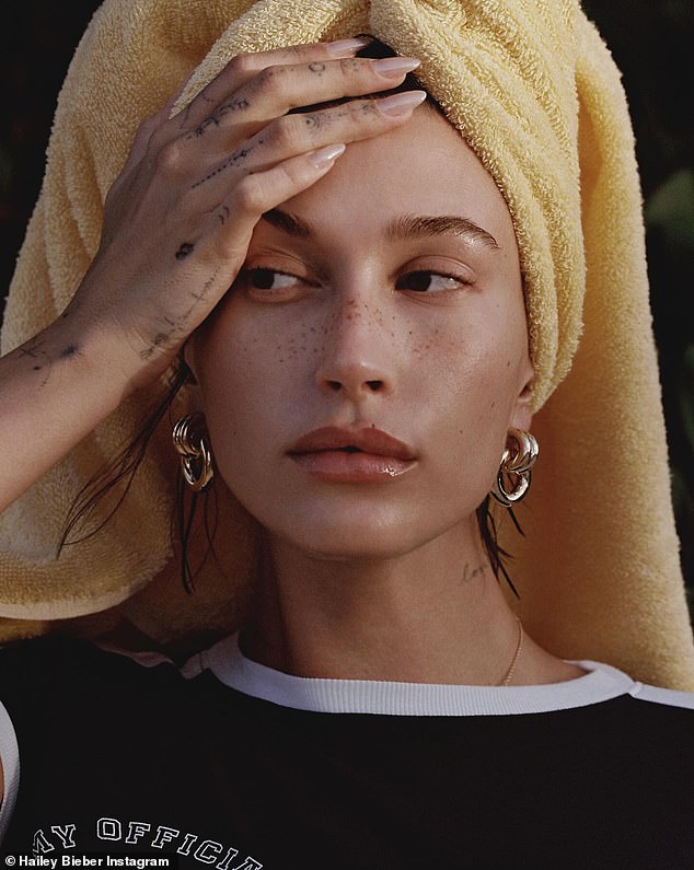 Another photo in the series showed her with her hair up in a yellow towel while wearing a black T-shirt and chunky gold interlocking hoop earrings.