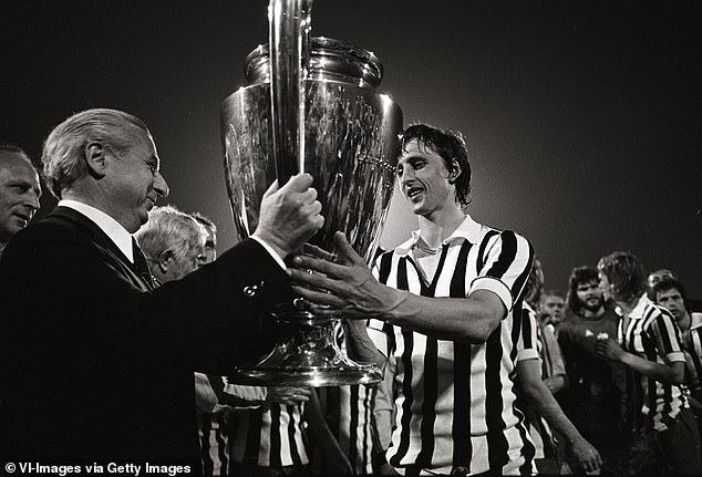 Ajax legend Johan Cruyff, wearing a Juventus shirt, receives the European Cup in 1973. Ajax defeated the Italian side 1-0 in the final in Belgrade, making it a hat-trick of victories