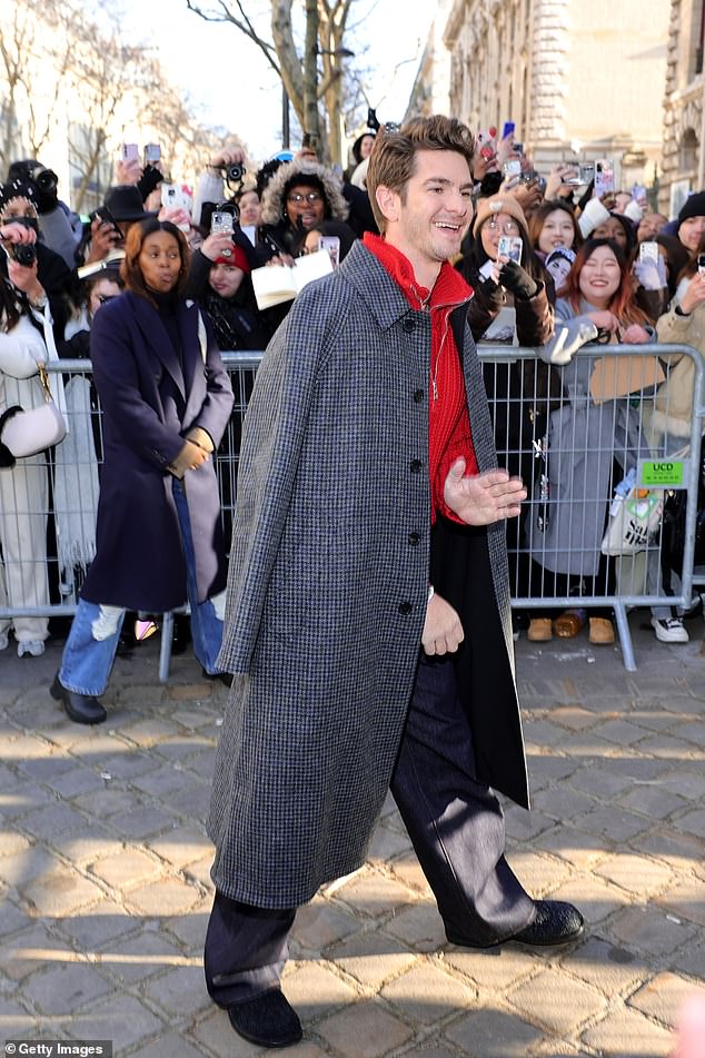 The actor, 40, looked cheerful as he posed for the cameras and completed his look with a trench coat