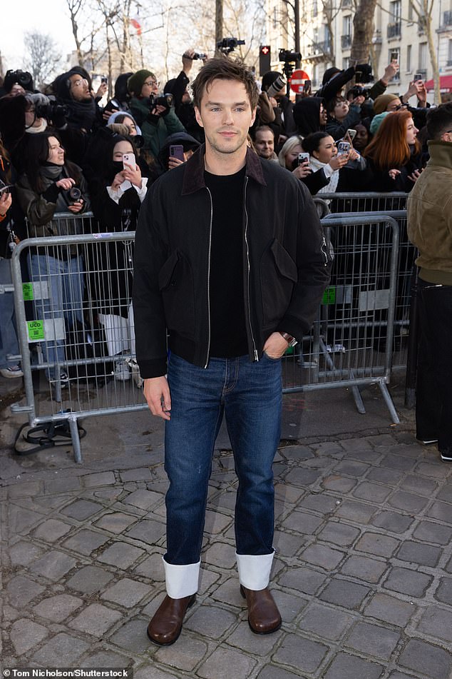 Nicholas Hoult opted for a black top with a matching jacket and dark blue jeans and completed the look with brown shoes