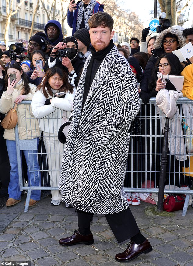 Singer James Blake wore a patterned jacket, black pants and dark brown shoes