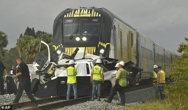 Emergency services work at the scene of a fatal incident involving a vehicle and a Brightline train in Melbourne on January 12