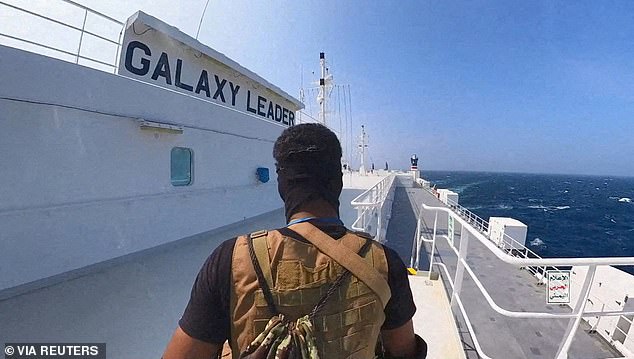 A Houthi fighter is pictured aboard a cargo ship in the Red Sea